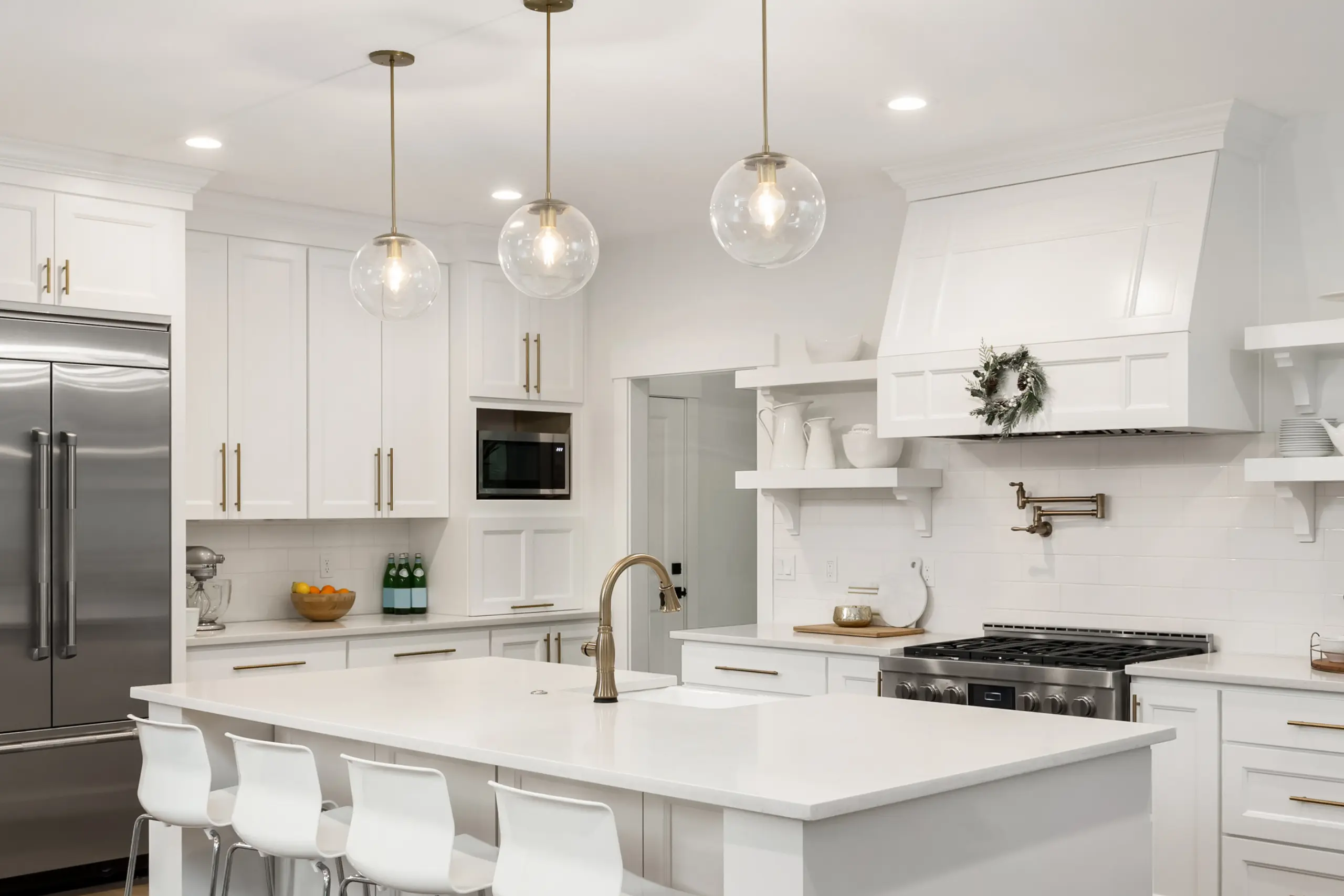 beautiful kitchen in new luxury home with island, pendant lights